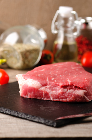 raw steak black angus meat spices on a gray wooden backgroundの写真素材