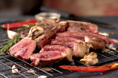 rare steak Porterhouse pepper rosemary garlic on a dark background close upの写真素材