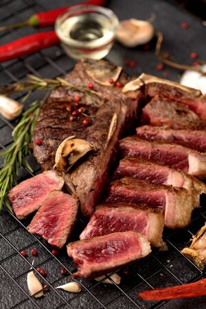 rare beef steak Porterhouse salt rosemary pepper on a dark backgroundの写真素材