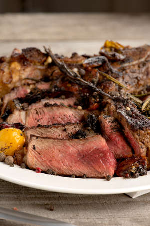 rare steak BBQ white plate spices on a gray wooden backgroundの写真素材