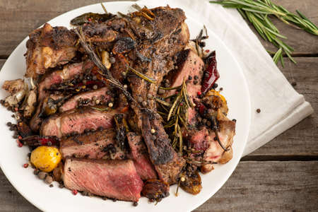 rare steak BBQ white plate spices on a gray wooden backgroundの写真素材