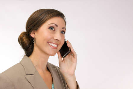 Young corporate woman smiling and talking on a mobile phoneのeditorial素材