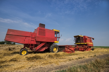 Combine working in field in fertile plainの写真素材