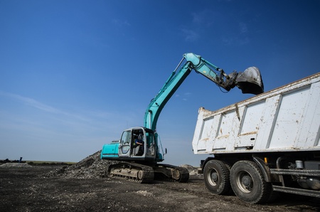 Dredger loading truck on the siteの写真素材