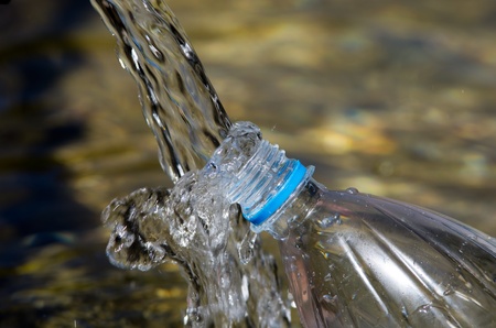 taking water from spring in bottle