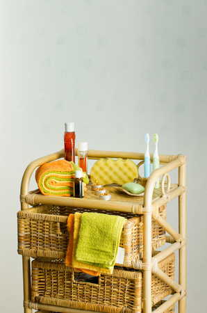 Bathroom accessories on bamboo shelf with basketsの写真素材