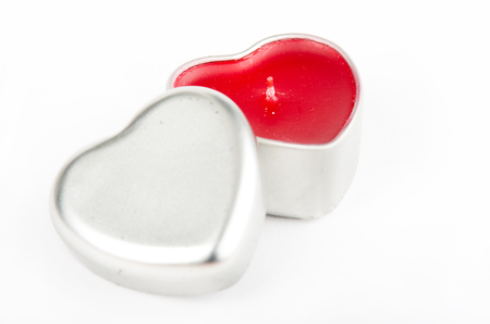 Heart shaped candle in metal box isolated on white backgroundの写真素材