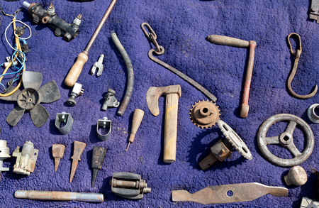 Old rusty equipment arranged on violet backgroundの写真素材