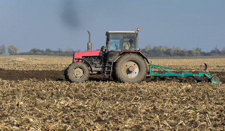 Tractor plowing on field