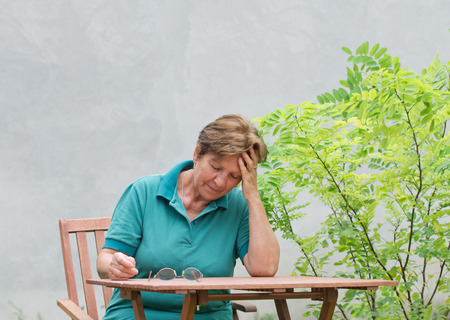 Senior woman with hand on foreheadの写真素材