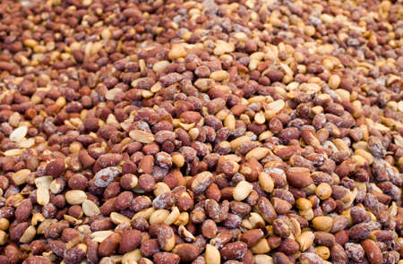 Roasted salted peanut seeds on pile as background
