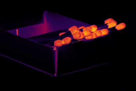 Glowing matches in box on dark backgroundの写真素材