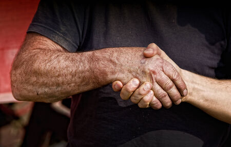 Close up of two male worker's hands making dealの写真素材