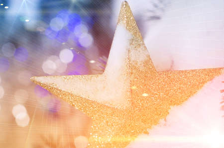 Golden sparkle star in snow as Christmas decorationの写真素材