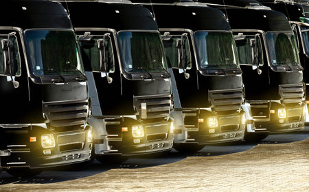 Freight trucks with lights on parked on parking, image in solarisation technique