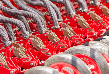 Close up of pipes and wheels of agricultural machinery, seederの写真素材