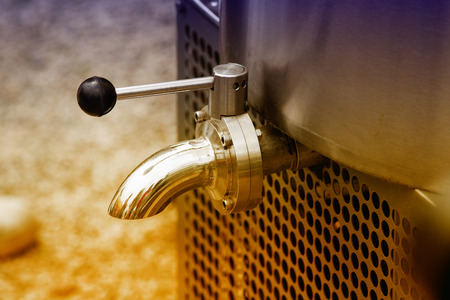Close up of faucet on milk cooling tank in dairy plantの写真素材