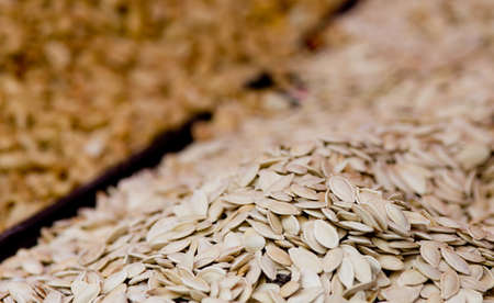 Close up of pumpkin seeds in peels on pileの写真素材