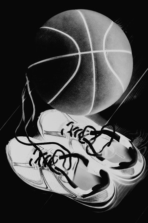 Sport concept. Basket ball with sneakers on black backgroundの写真素材