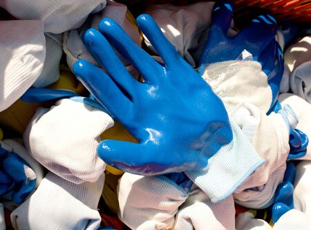 Blue rubber protective gloves on pile for saleの写真素材