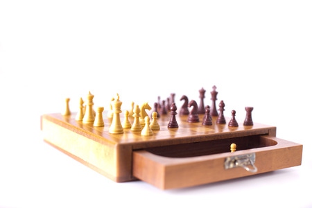 Chessmen on wooden board isolated on white backgroundの写真素材