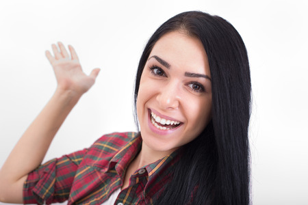 Beautiful young woman with big smile on her face showing something with hand. Isolated on white backgroundの写真素材