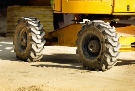 Close up of construction vehicle wheels at building siteの写真素材