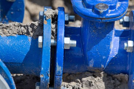 Close up of new blue metal pipes and joints for tap water at construction site