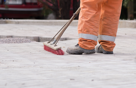 Construction worker sweeping on the building siteの写真素材