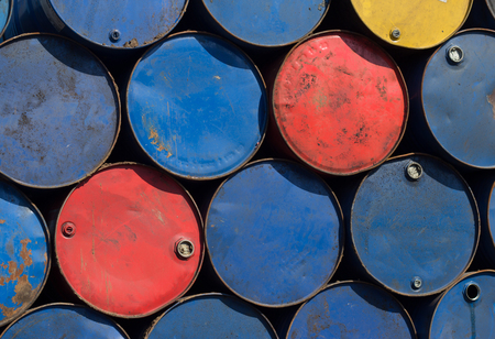 Oil barrels or chemical steel drums stacked on scrapyard
