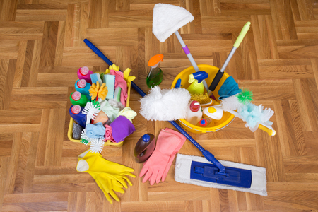 Top view of cleaning supplies and tools on the parquet. House cleaning service conceptの写真素材