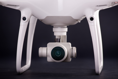 Close up of small camera on gimbal of drone against black backgroundの写真素材