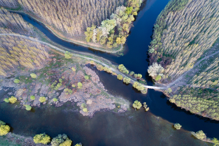 Aerial image of beautiful river and forest landscape shot with droneの写真素材