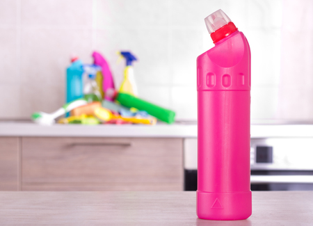 Cleaning product on table with bunch of detergents and equipment on kitchen countertop in...