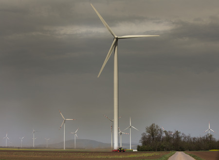Wind turbine farm in field in spring time. Renewable energy sources concept