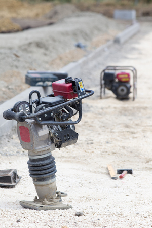 Close up of vibrating plate compactor machine at road construction siteの写真素材