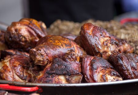 Pile of roasted pork knuckle on metal plate. Traditional balkan fat foodの写真素材