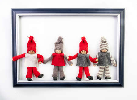Funny christmas dwarfs in image frame on white backgroundの写真素材