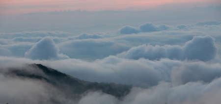 Aerial view of clouds shoot above cumulus from mountain peakの写真素材
