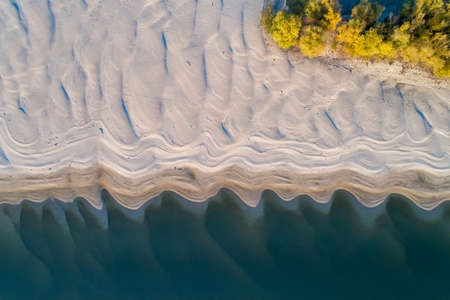 Aerial view of Danube river coast on low water level in autumn at sunset, shoot from droneの写真素材