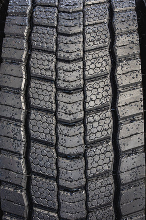 Close-up view of tire showcasing its intricate tread design, vital for traction and performance on...
