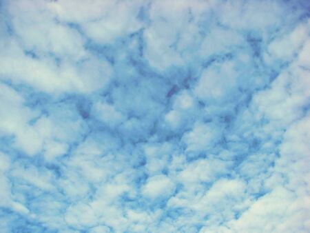 a detail of a beautiful blue sky with white clouds  in springtimeの写真素材