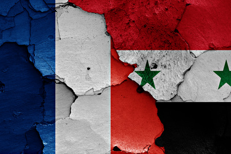 flags of France and Syria painted on cracked wallの写真素材