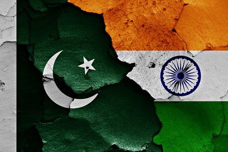 flags of Pakistan and India painted on cracked wallの写真素材