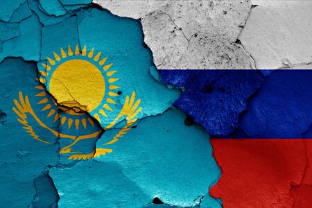 flags of Kazakhstan and Russia painted on cracked wallの写真素材