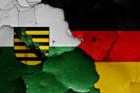 flags of Saxony and Germany painted on cracked wallの写真素材