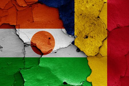 flags of Niger and Chad painted on cracked wallの写真素材