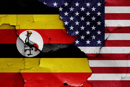 flags of Uganda and USA painted on cracked wallの写真素材