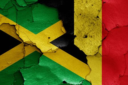 flags of Jamaica and Belgium painted on cracked wallの写真素材
