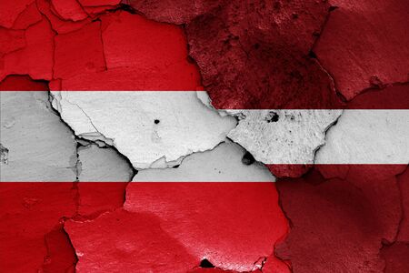 flags of Austria and Latvia painted on cracked wallの写真素材